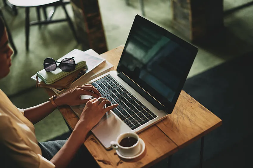 unrecognizable-asian-woman-sitting-cafe-working-laptop (1)